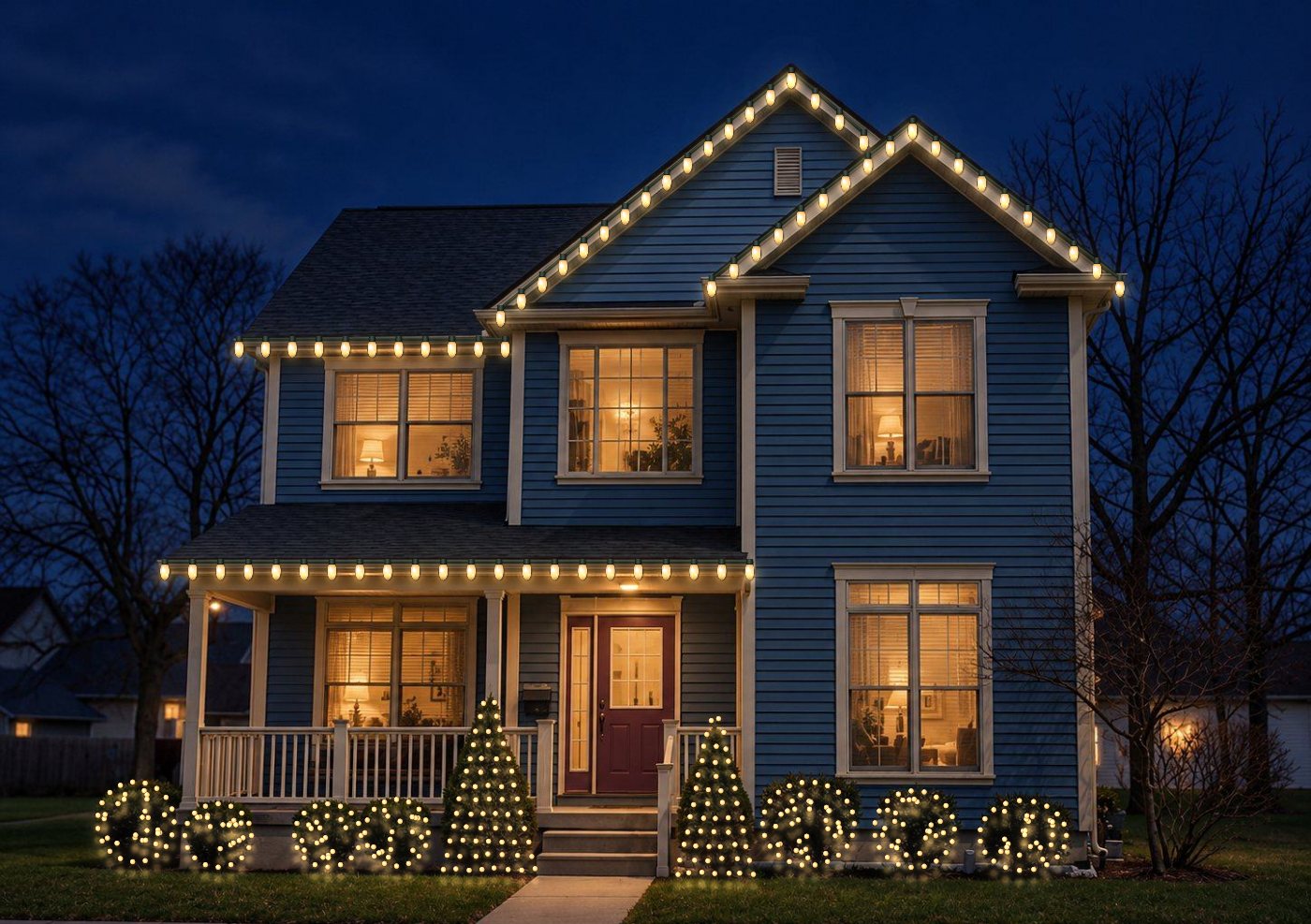 Example home with Christmas lights on the rooflines, porch and bushes
